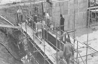 Barrowing concrete for a wall section.